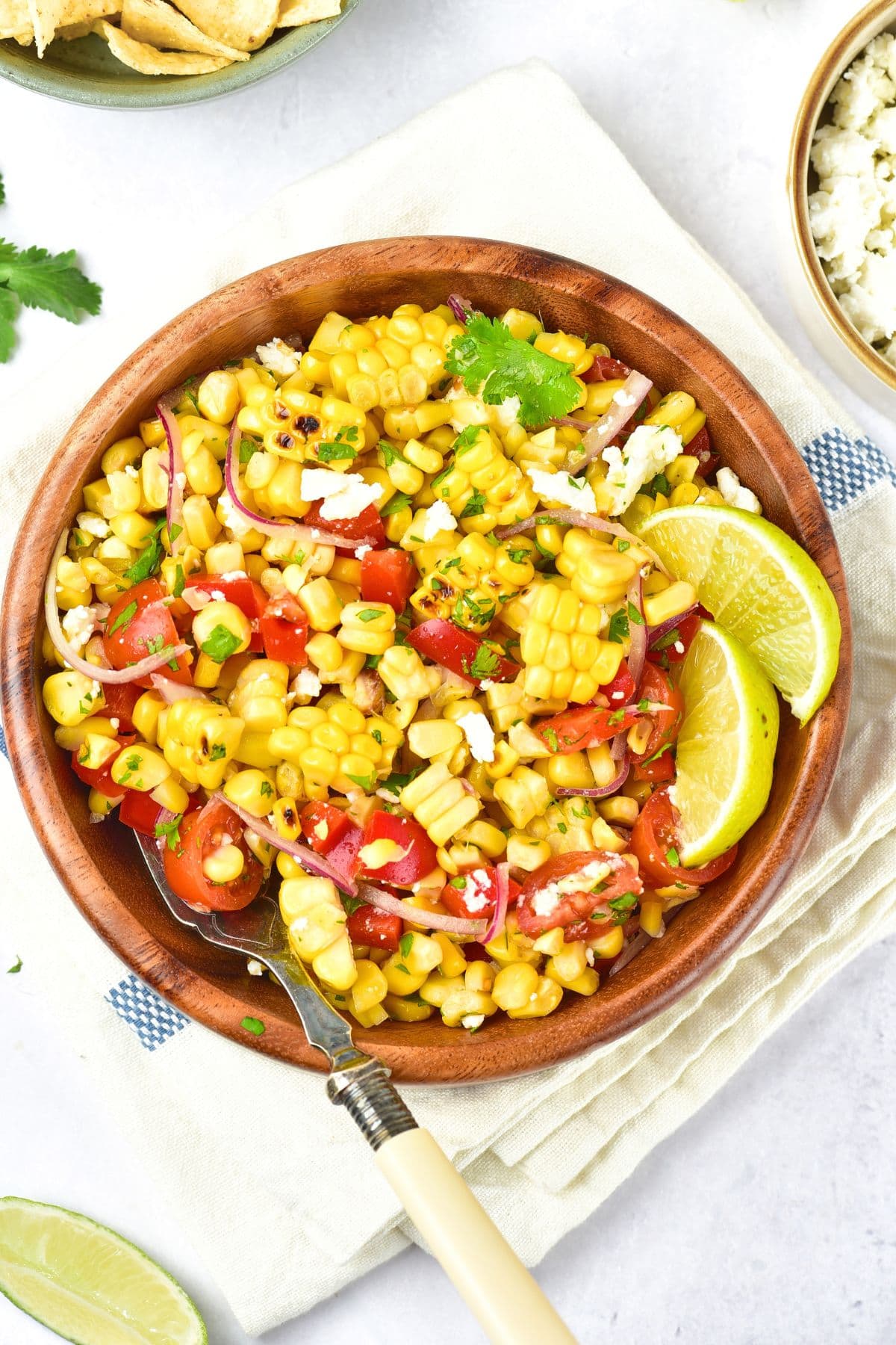 Easy Grilled Corn Salad (Gluten-Free, Dairy-Free Option) Top down view of easy grilled corn salad in a wooden bowl.