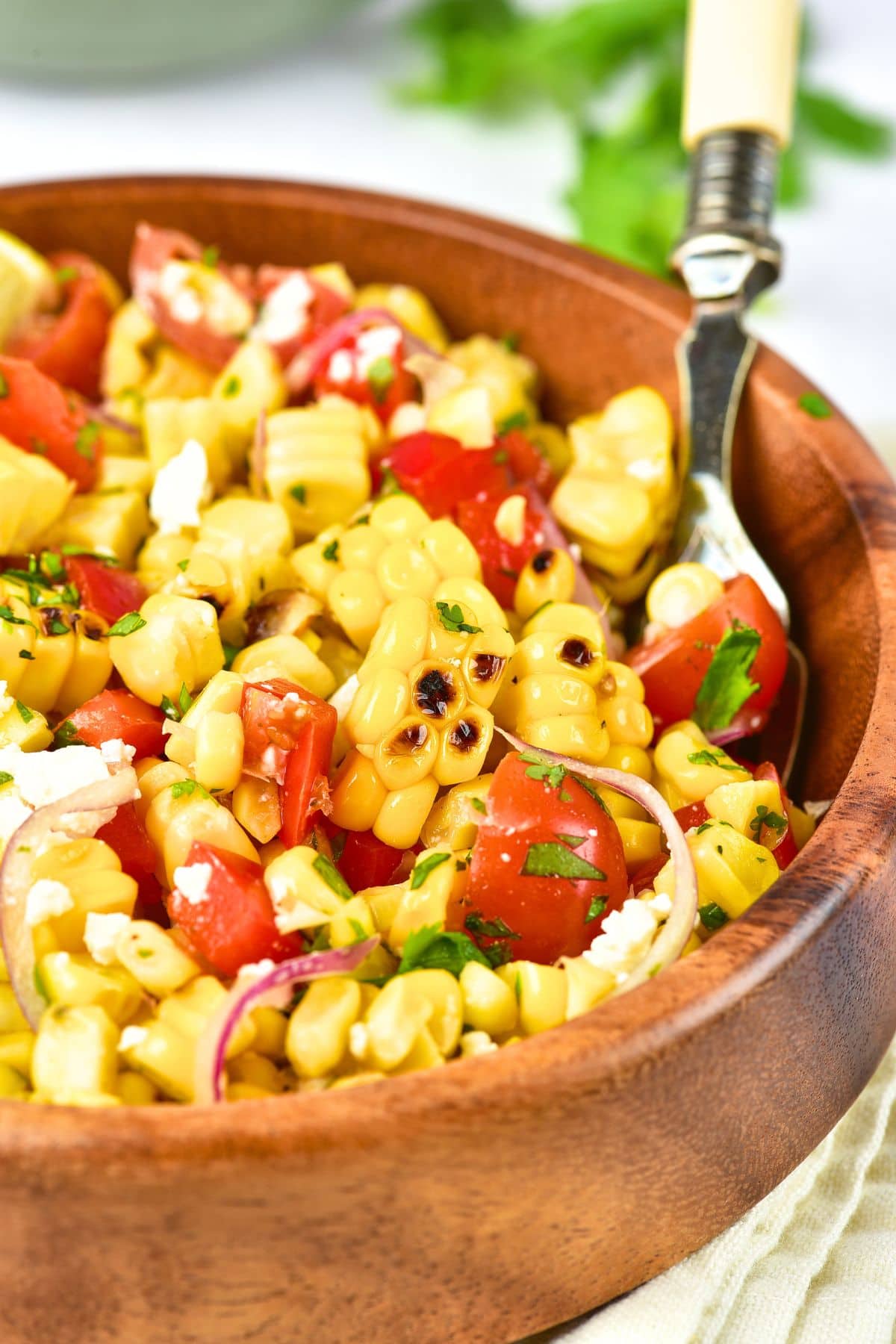 Gluten-Free Grilled Corn Salad (Dairy-Free Option) Up close view of gluten-free grilled corn salad in wooden bowl.