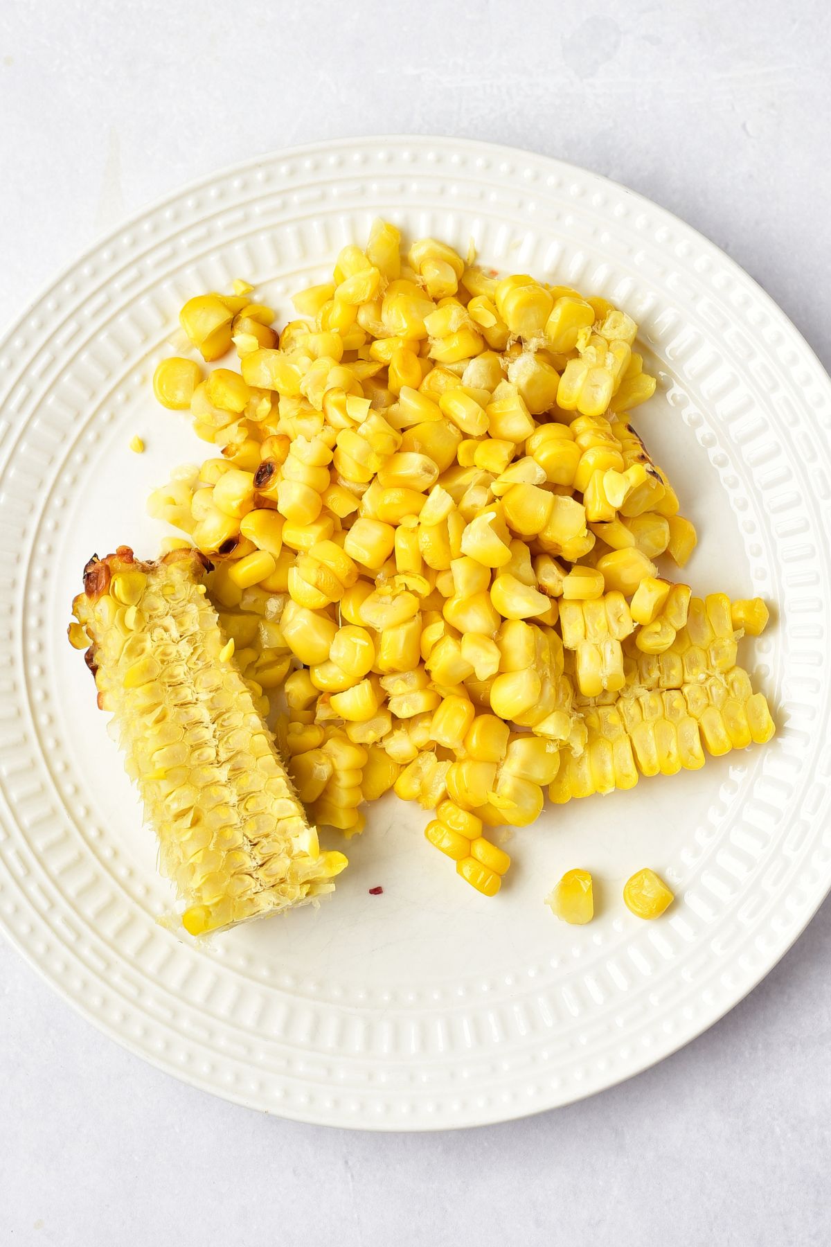 Mexican Street Corn Salad Fresh corn kernels on white plate