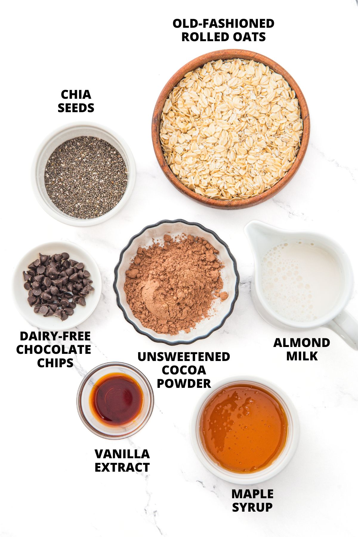 Ingredients for chocolate overnight oats recipe laid out on marble board.