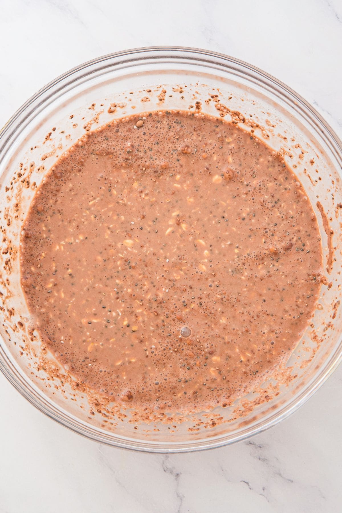 A bowl of mixed chocolate oat milk mixture.