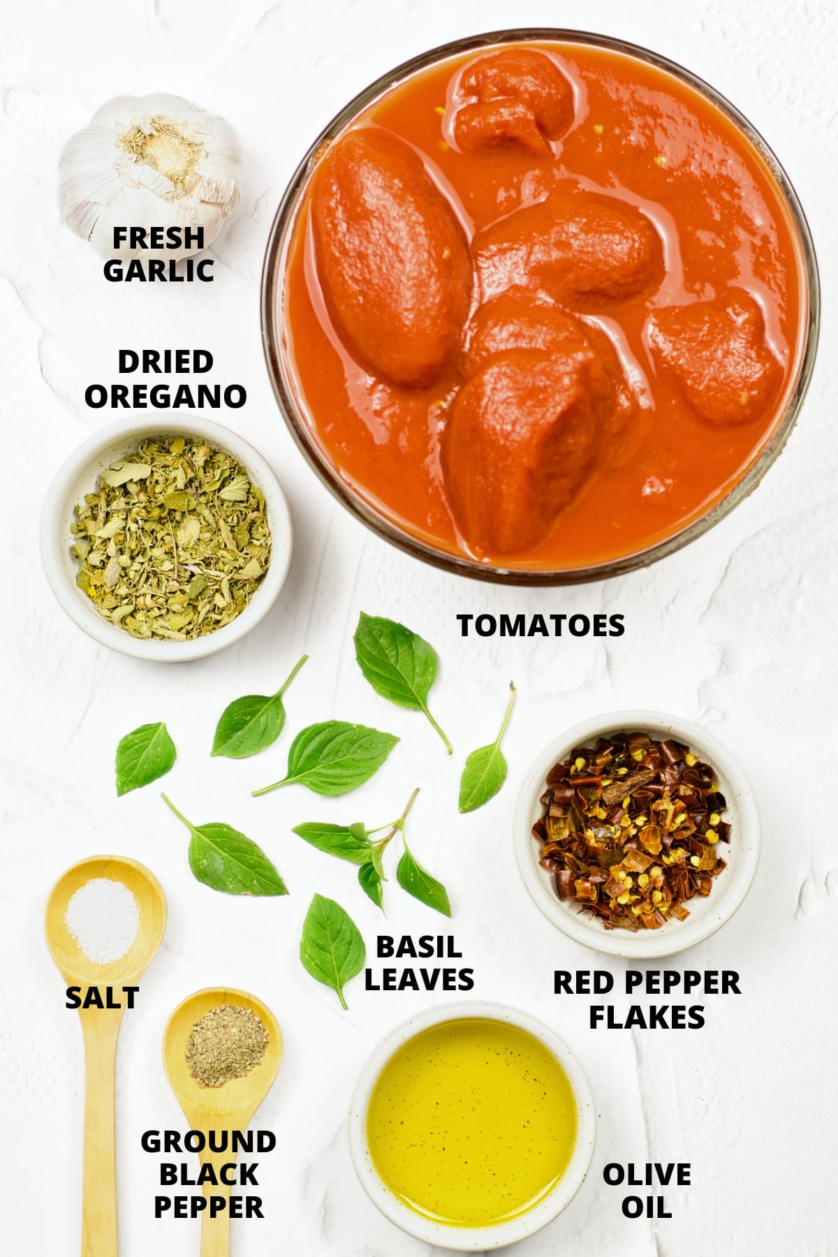 Ingredients for easy tomato marinara sauce recipe laid out on white board.