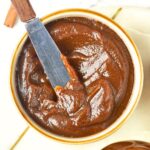 Butter knife in a bowl of apple pumpkin butter