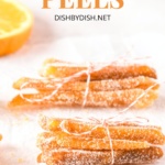 Bunches of tied candied orange peels on parchment paper.