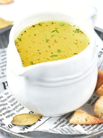 A small jug of homemade chicken stock.