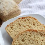 Sliced ciabatta on white plate.