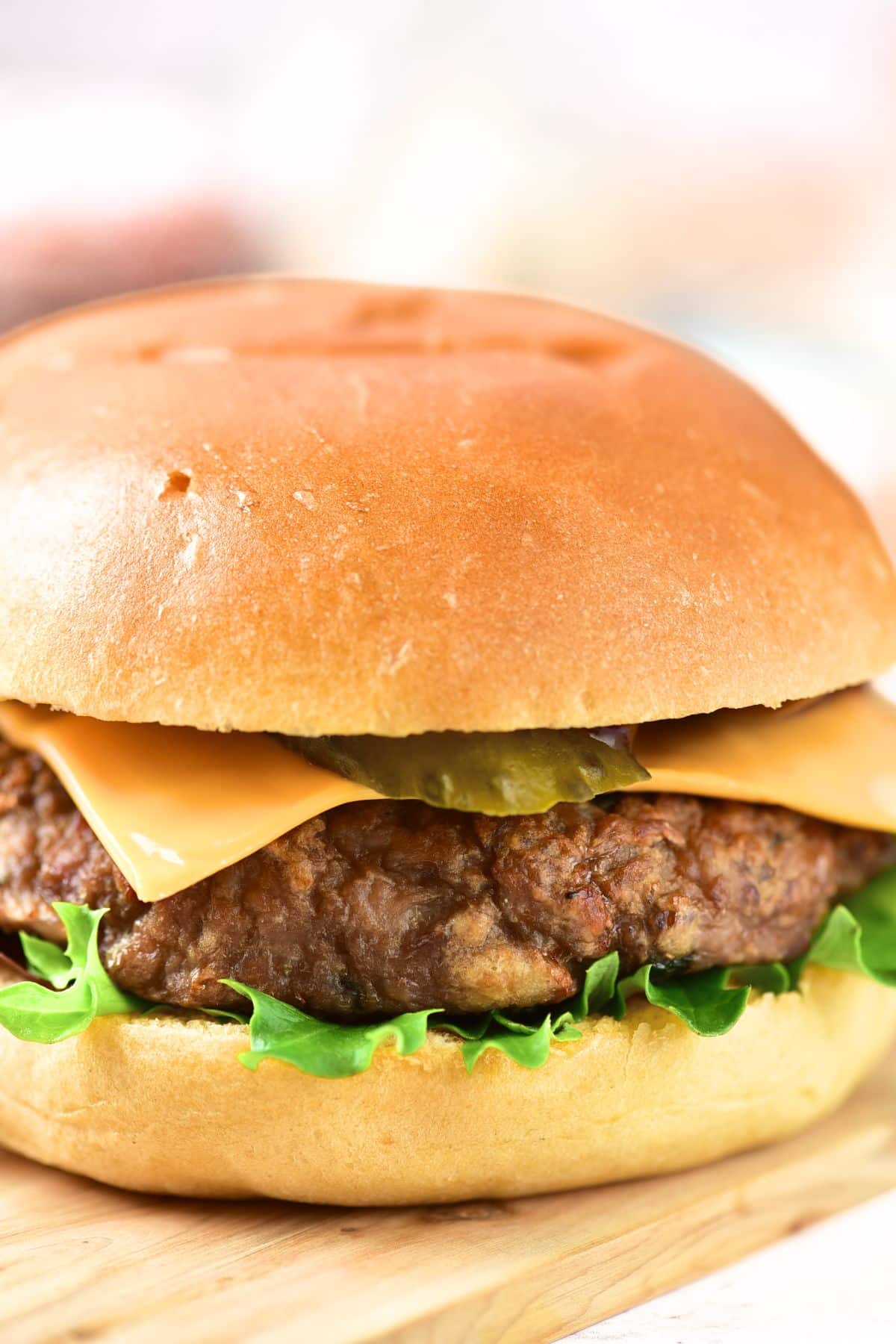 Up close view of gluten-free  burger on wooden board.