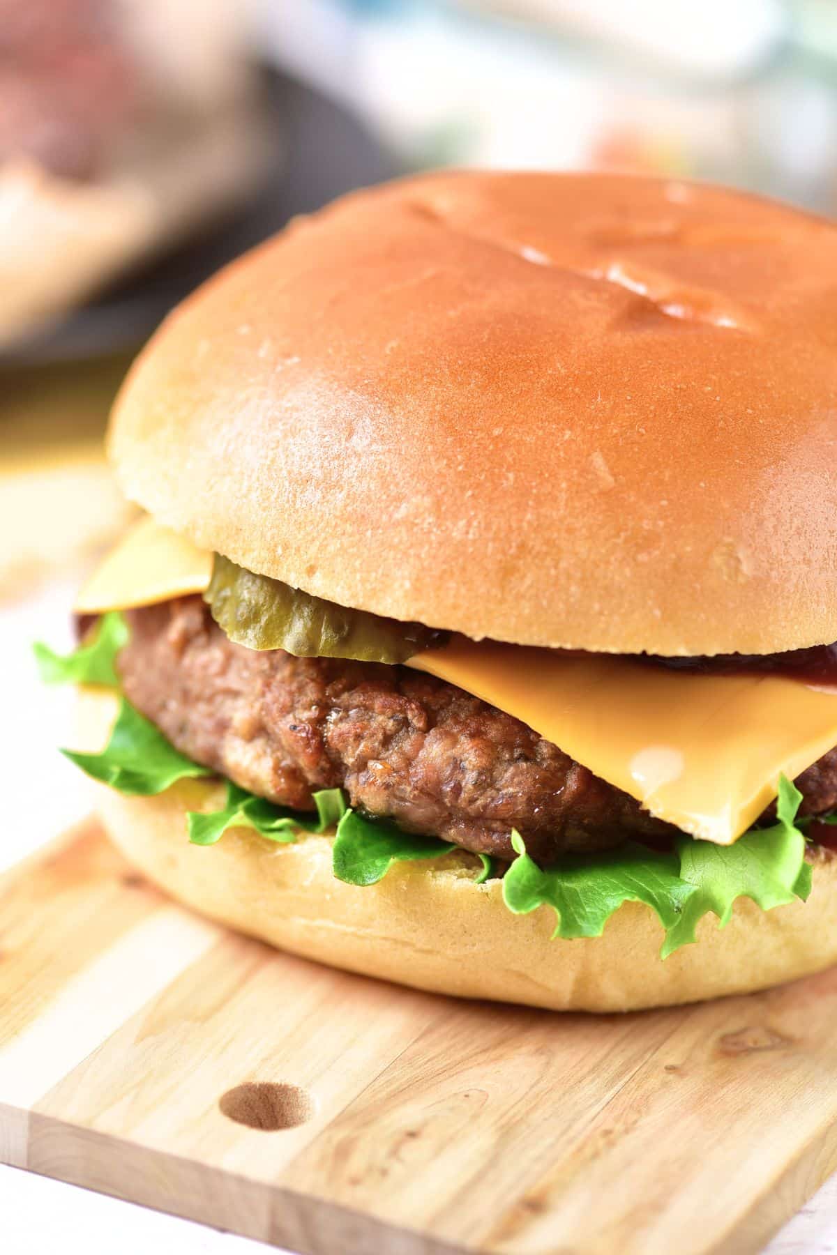 Gluten-free hamburger on wooden board.