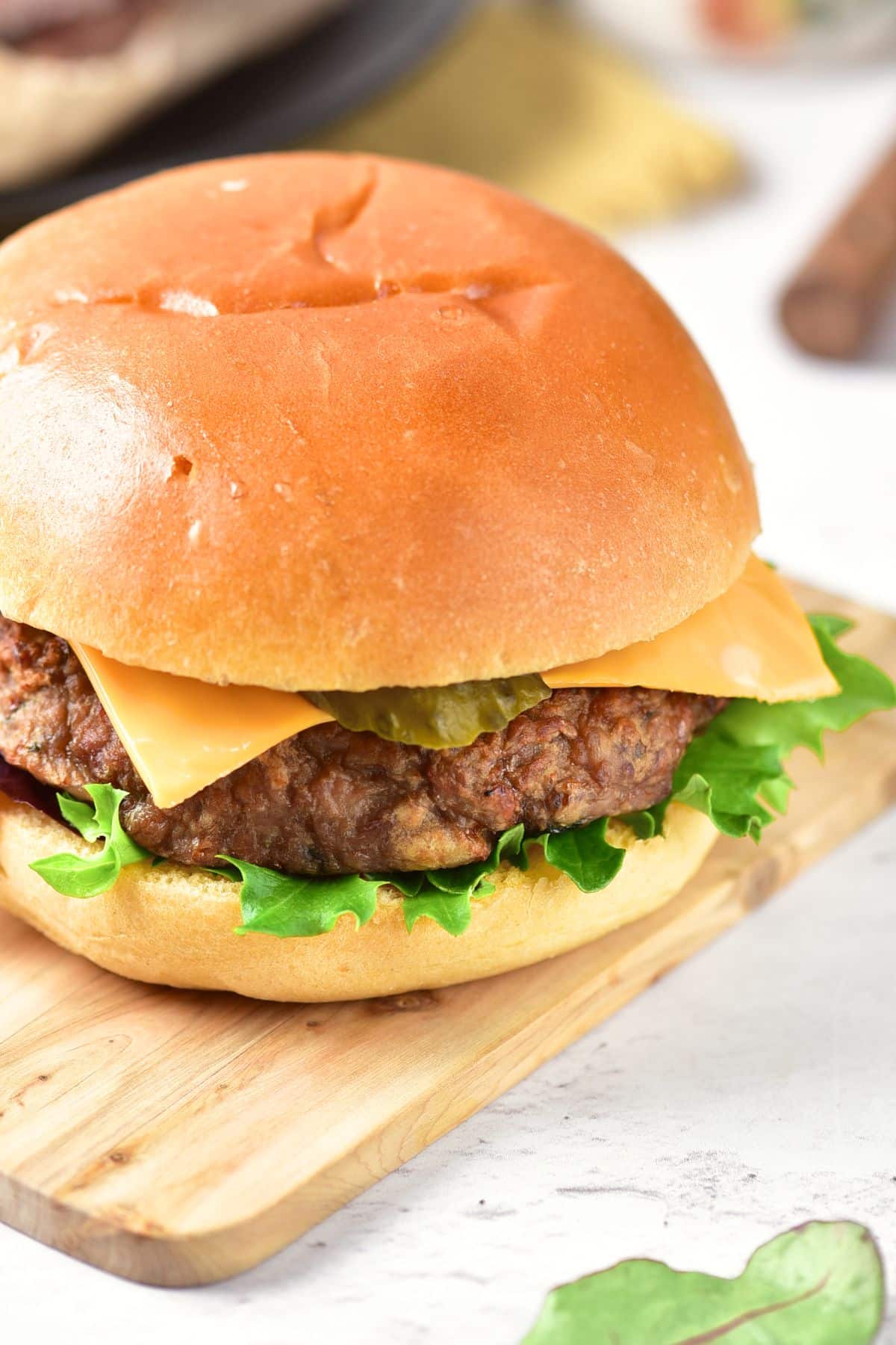 Up close shot of hambuger on wooden board.