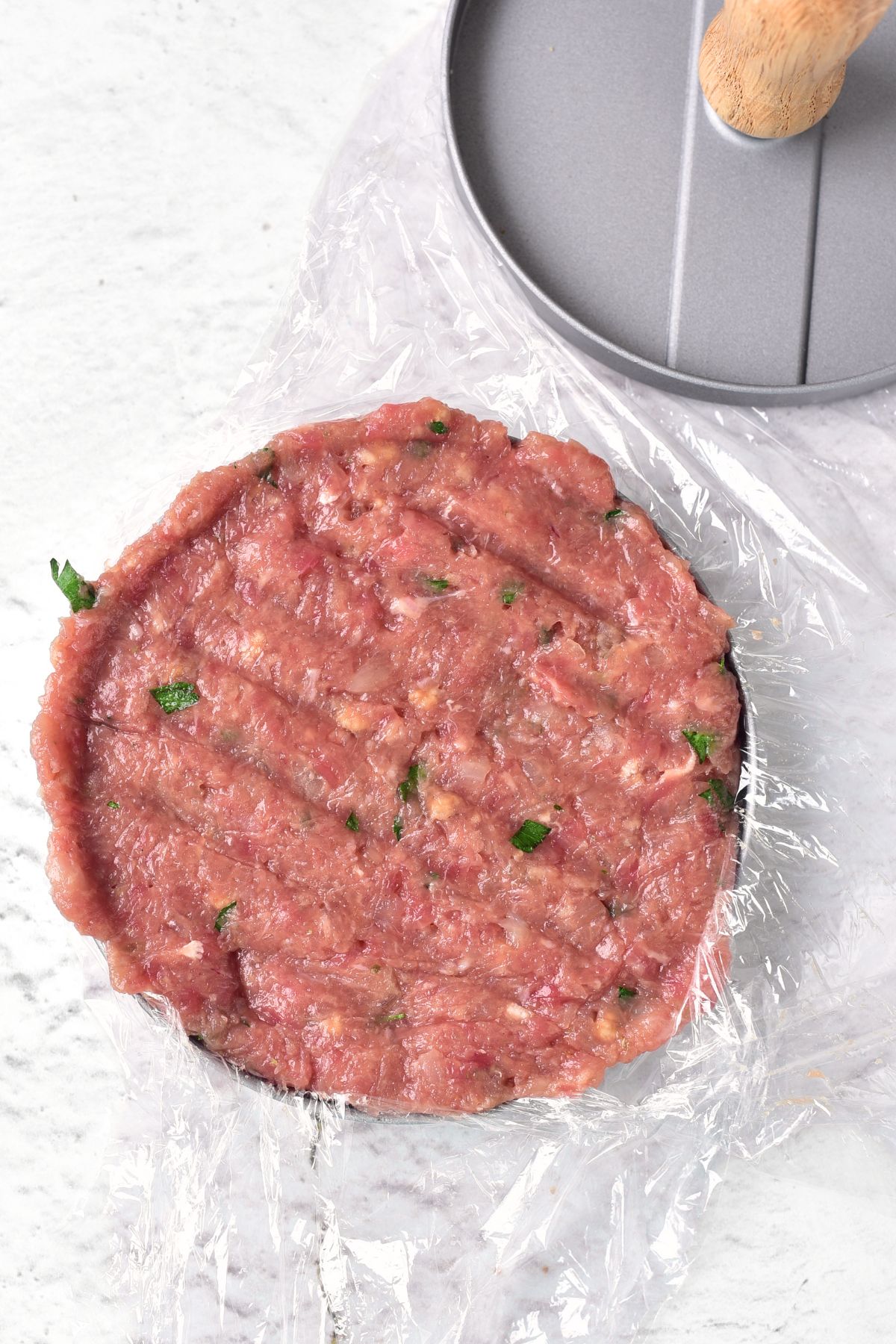 Making gluten-free burgers in patty maker.