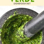 Grinding green sauce with a pestle and mortar.