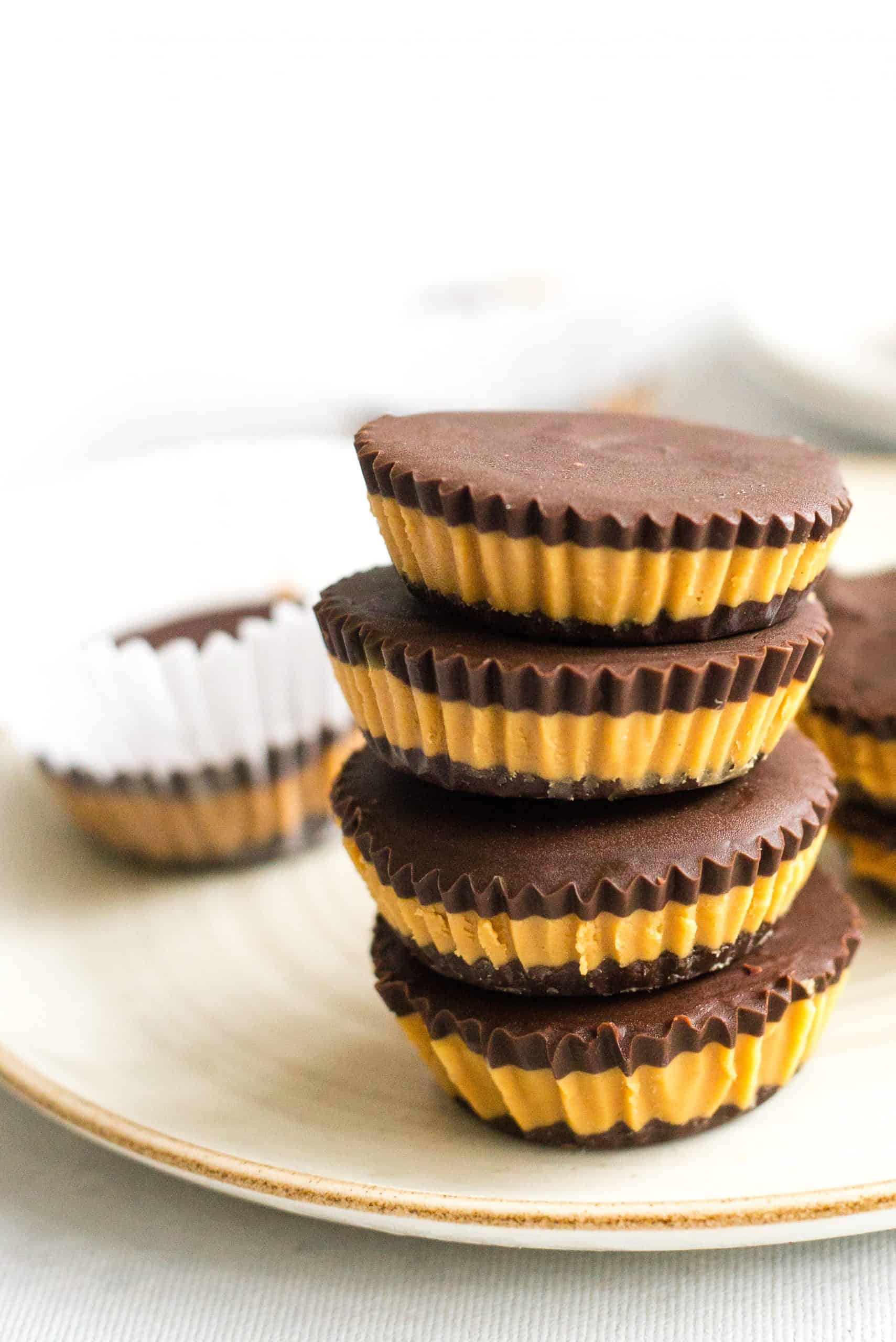 Gluten-free peanut butter cups stacked on a plate.