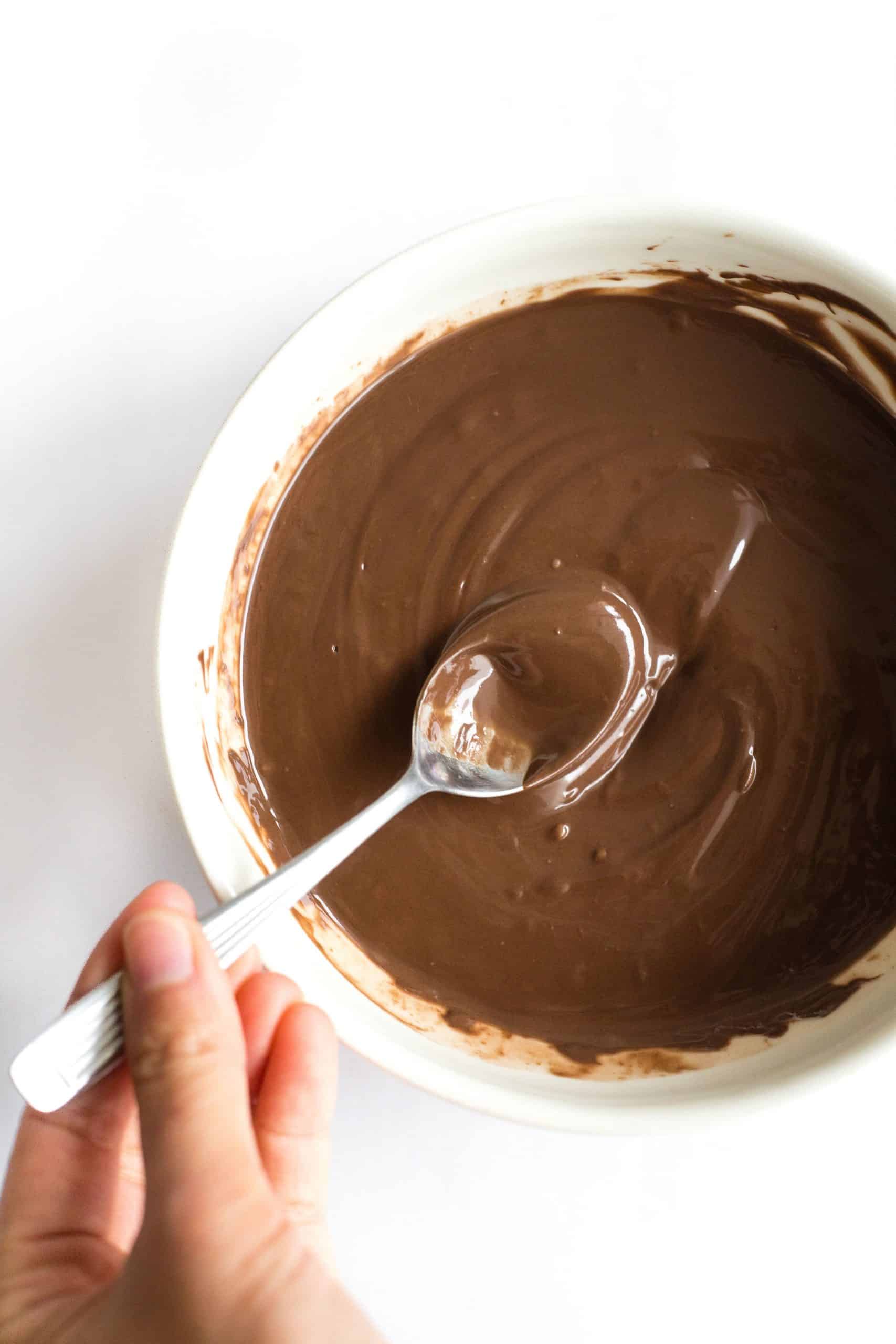 Mixing a bowl of melted chocolate.