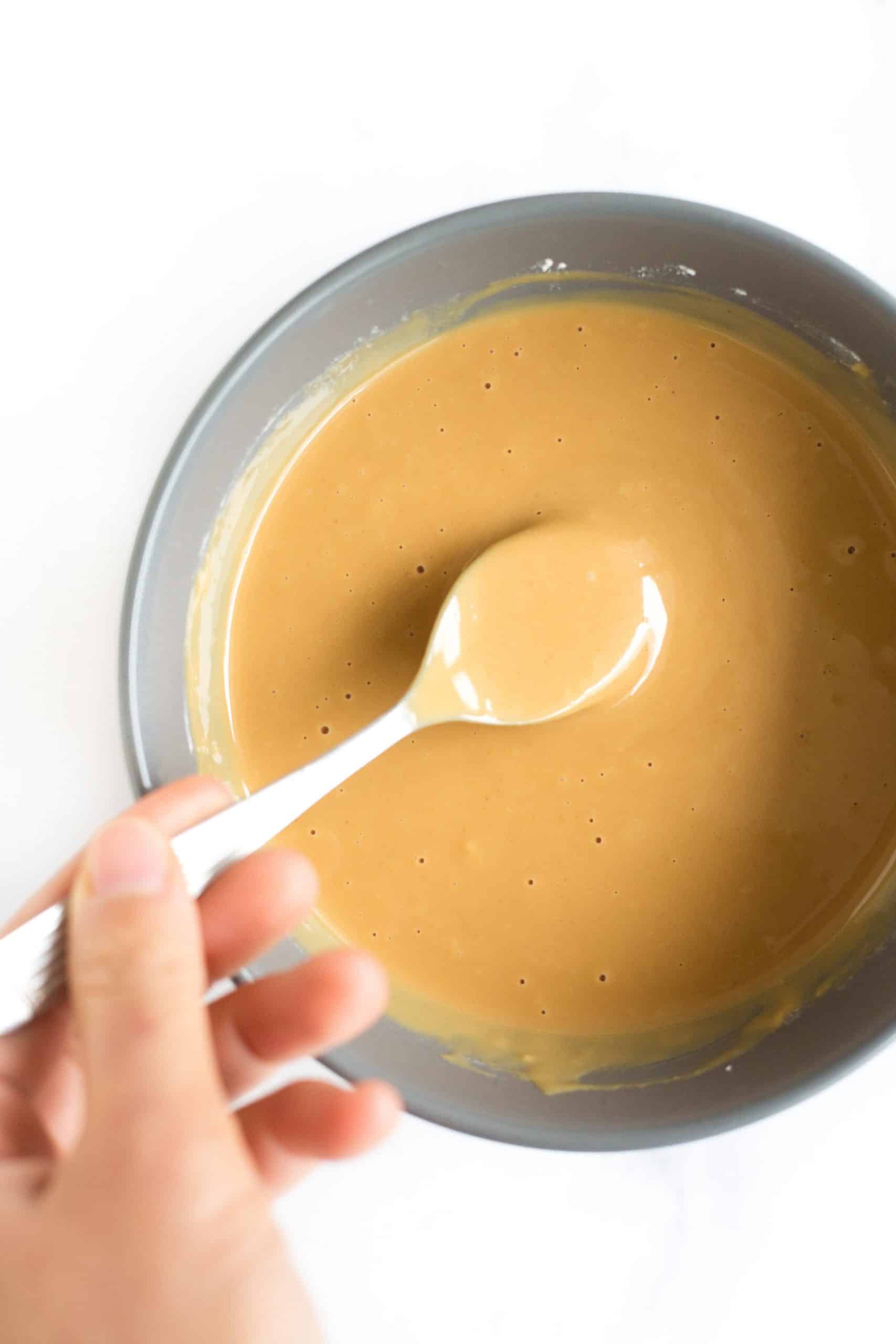 Mixing peanut butter mixture in a grey bowl.