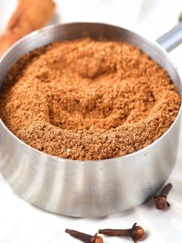 A measuring cup with homemade pumpkin pie spice