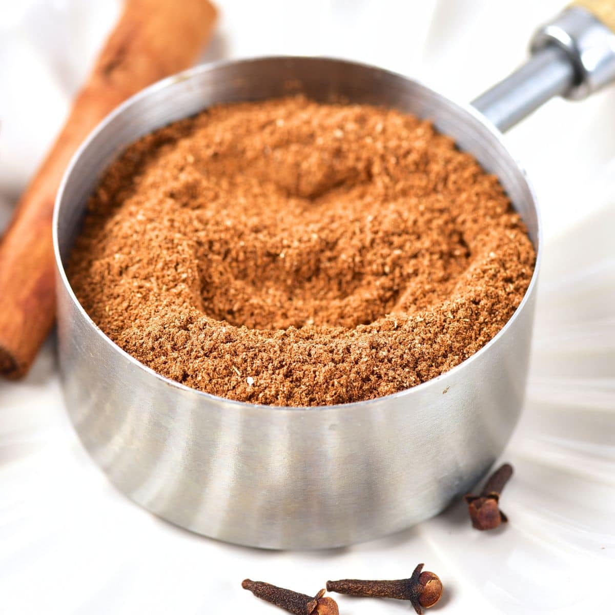 A measuring cup with homemade pumpkin pie spice