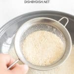 Sifting rice flour into a bowl.