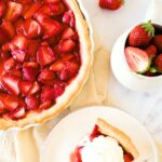 Top down view of slice of strawberry pie and fresh strawberries