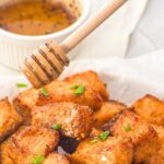 Drizzling hot honey over crispy salmon bites