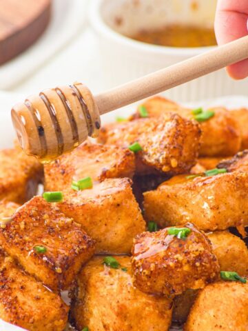 Drizzling honey on salmon bites