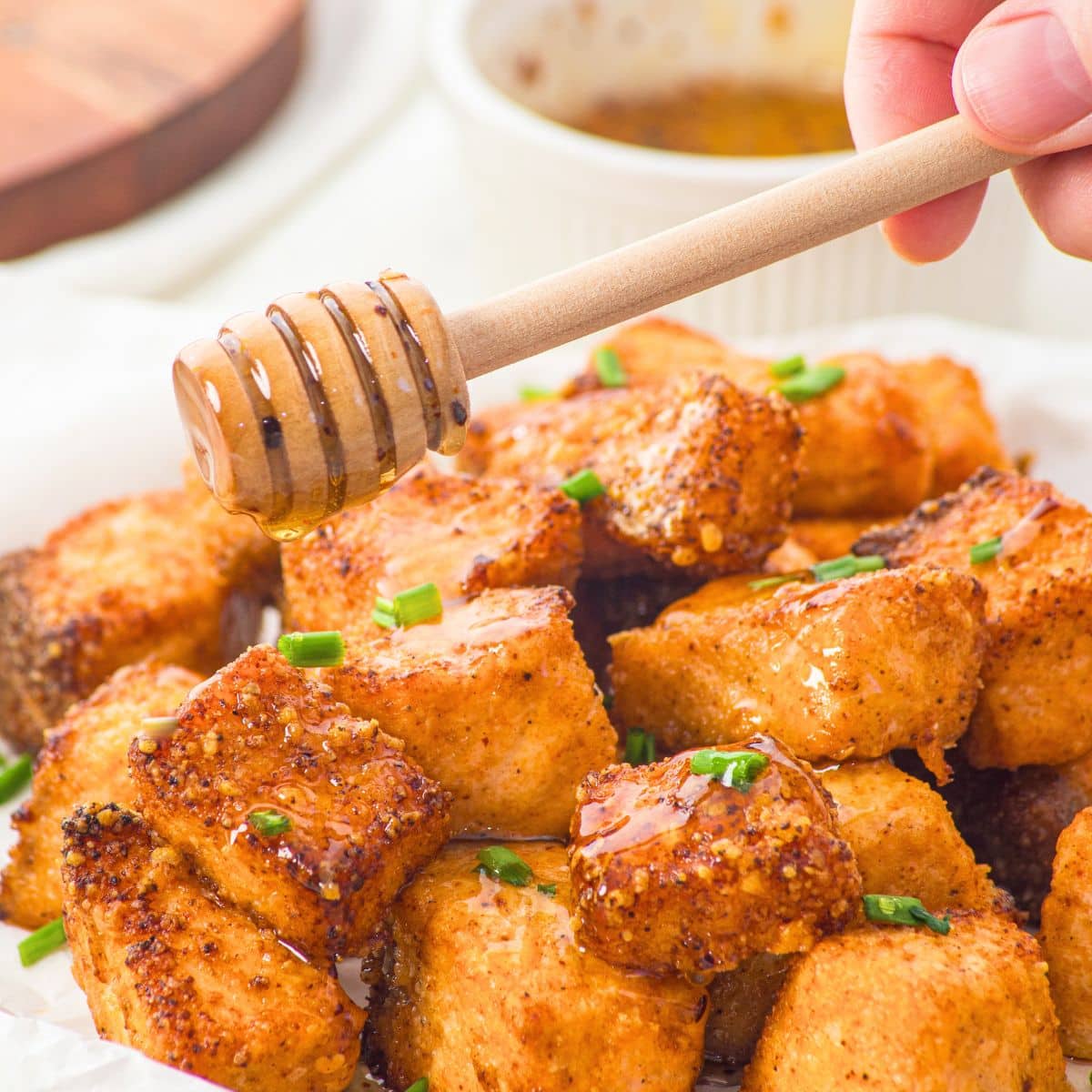 Drizzling honey on salmon bites