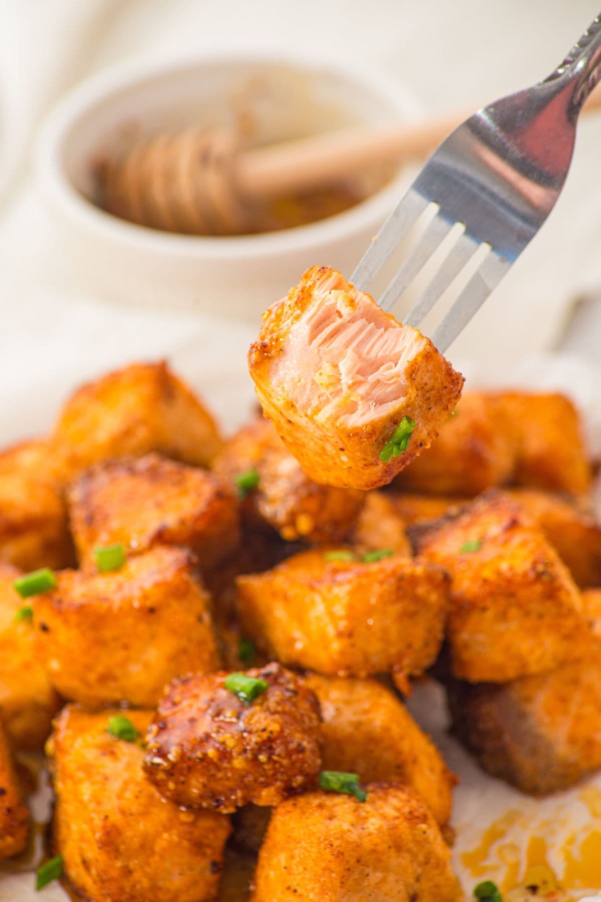 Fork holding up a half-eaten salmon cube