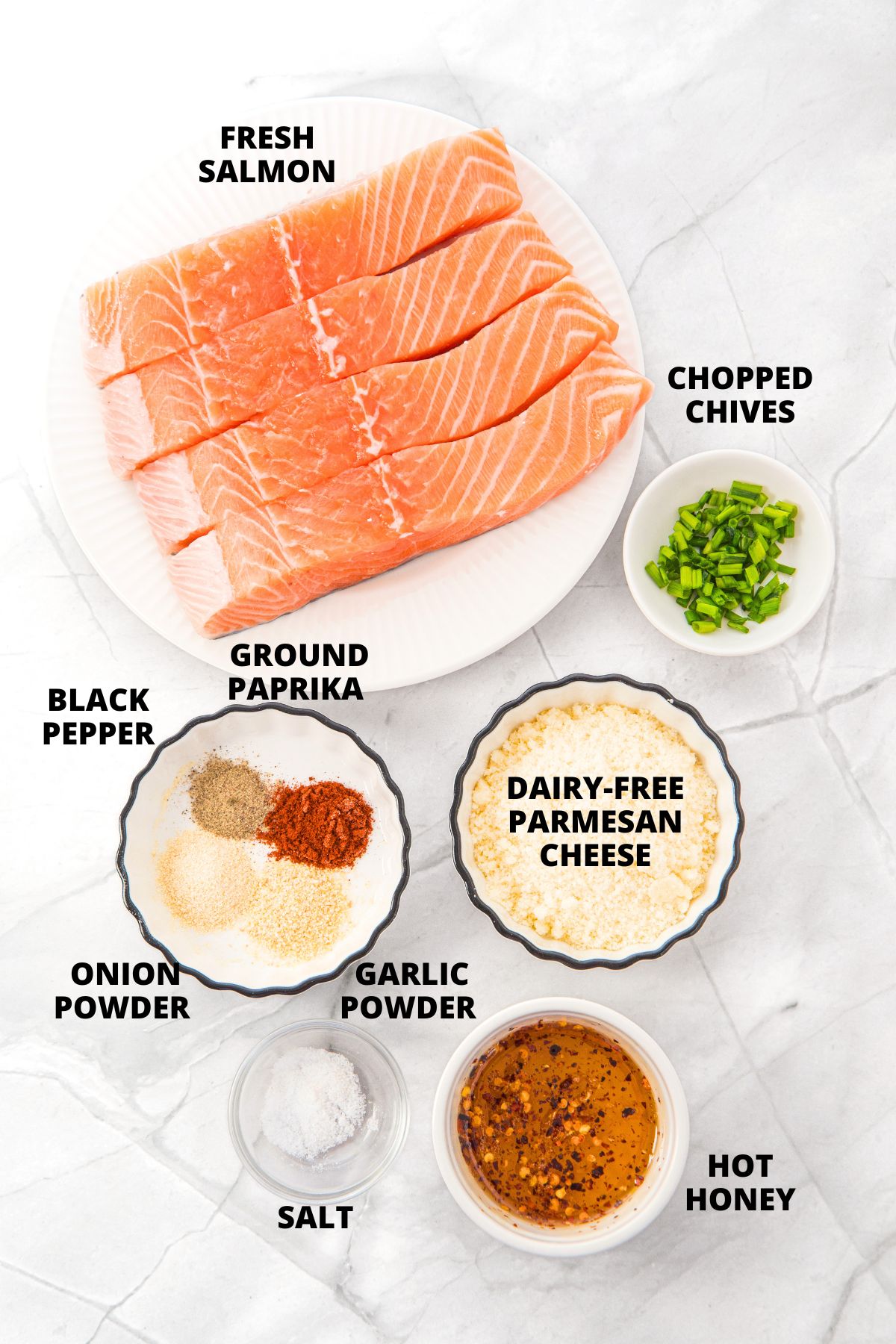 Ingredients for hot honey salmon bites recipe laid out on marble board.