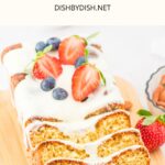 Sliced almond flour pound cake drizzled in glaze on wooden board