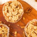 Top down view of almond flour pumpkin muffins on wooden board