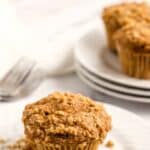 A plate with a muffin with streusel topping.