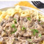 A plate of gf beef stroganoff on yellow towel.
