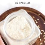 Hand holding a jar of flour.