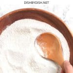 Mixing buckwheat flour in a wooden bowl.