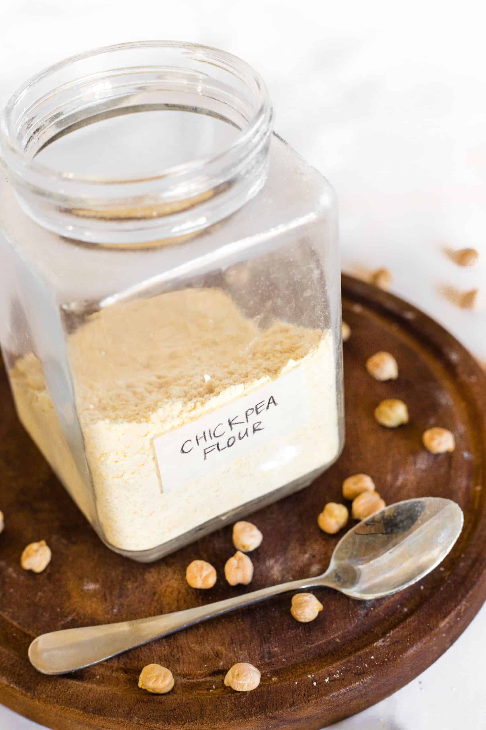 A half-filled glass jar with chickpea flour.