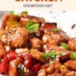 Up close view of kung pao chicken sprinkled with green onions.