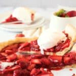 Holding up a slice of strawberry pie from pie dish.