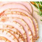 Top down view of sliced ham on wooden board