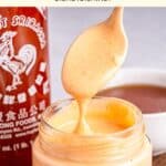 Holding up a spoonful of sriracha aioli from a jar