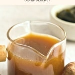 A glass jar of homemade vegan fish sauce.