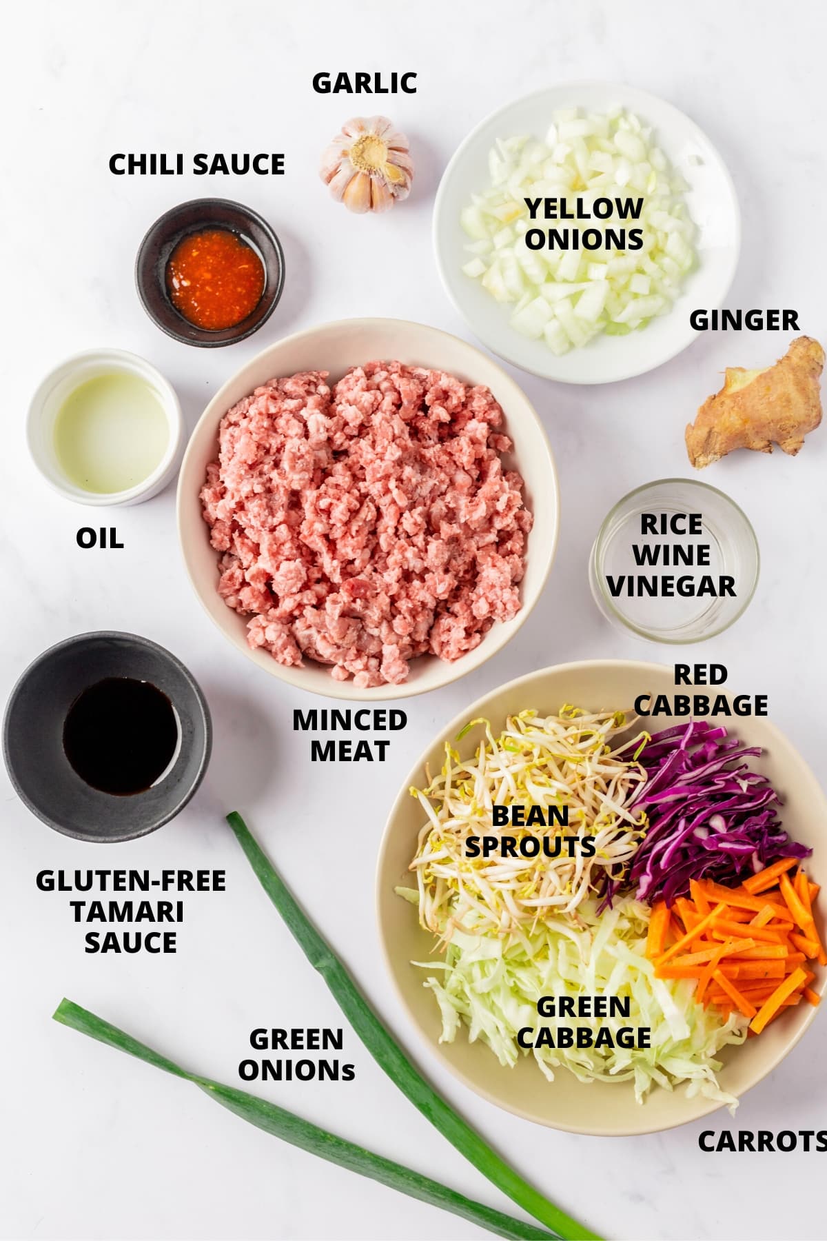 Ingredients for inside out egg roll recipe laid out on marble board.