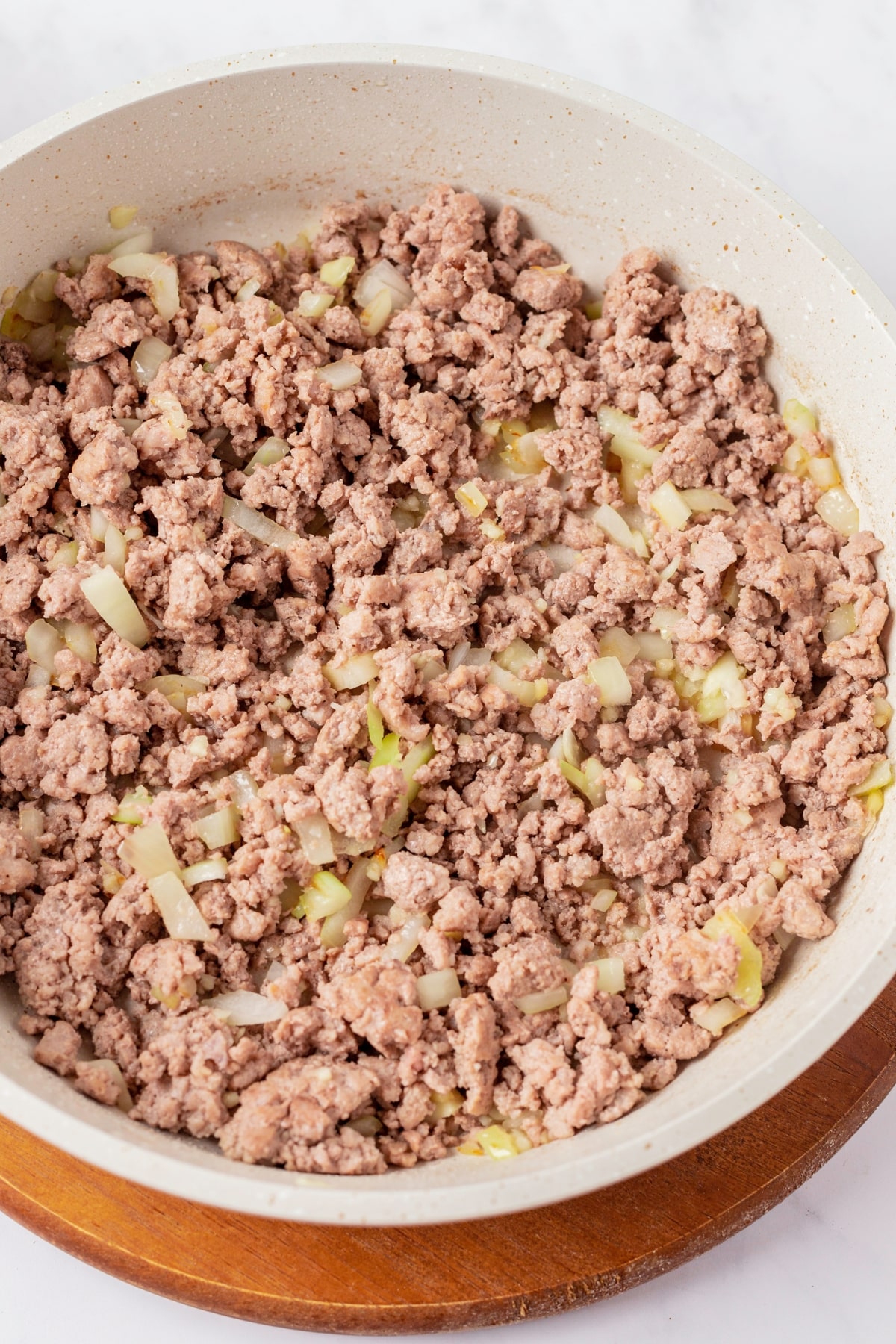 A bowl with sautéed minced meat and onions.