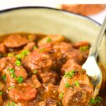 Up close view of a spoon in a bowl of Irish beef stew