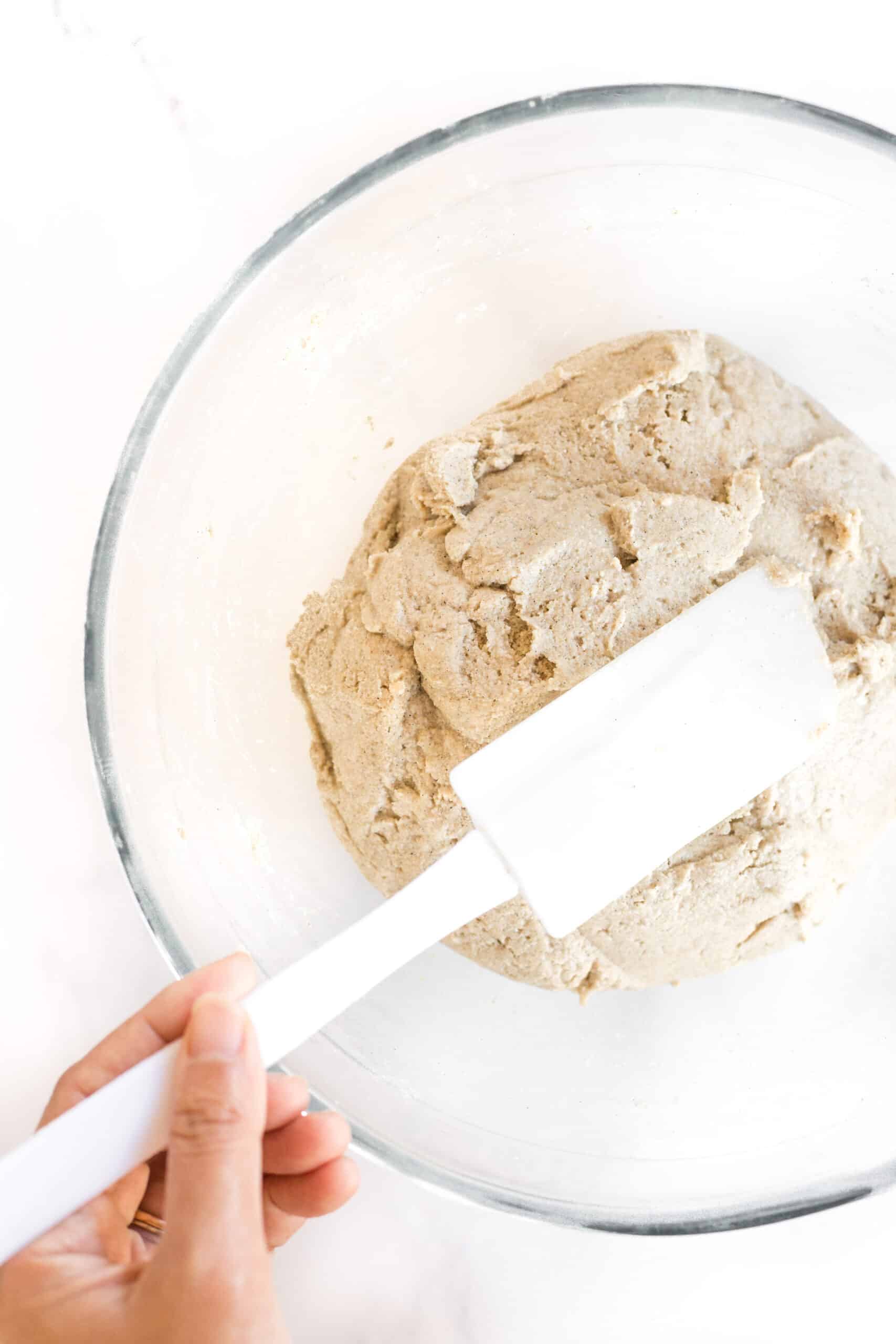 Shaping brown bread dough with spatula