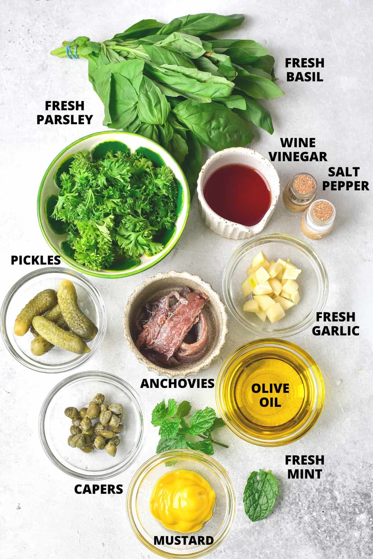 Ingredients for Italian salsa verde recipe laid out on board.