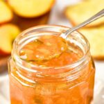 Holding up a spoonful of jalapeño peach jam