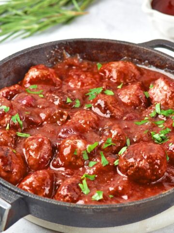 A skillet full of cranbery meatballs