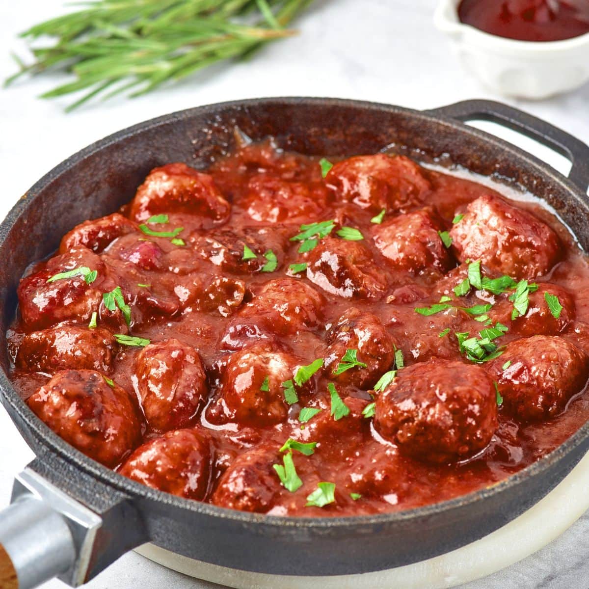 A skillet full of cranbery meatballs