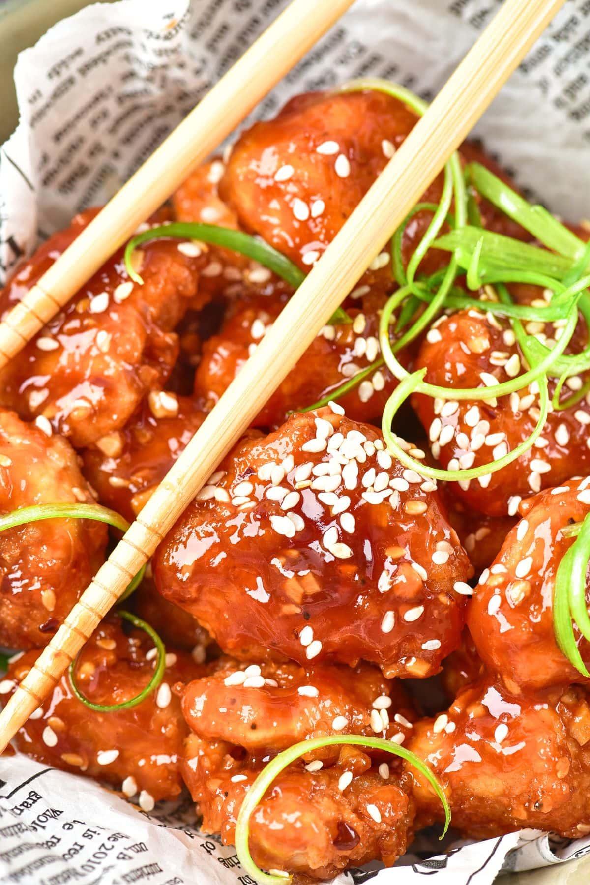 Up close view of chopsticks in Korean fried chicken 