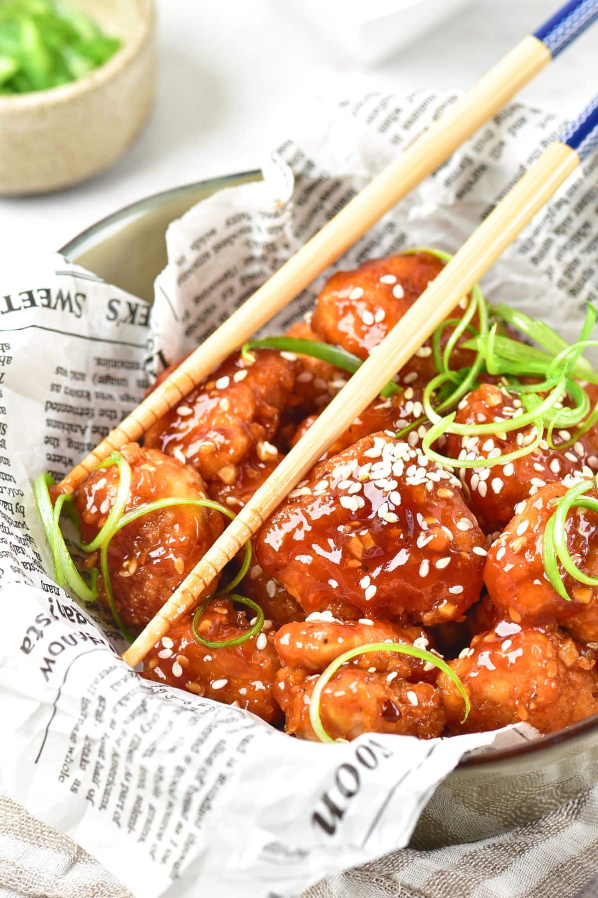 Chopsticks in bowl of gluten-free korean fried chicken