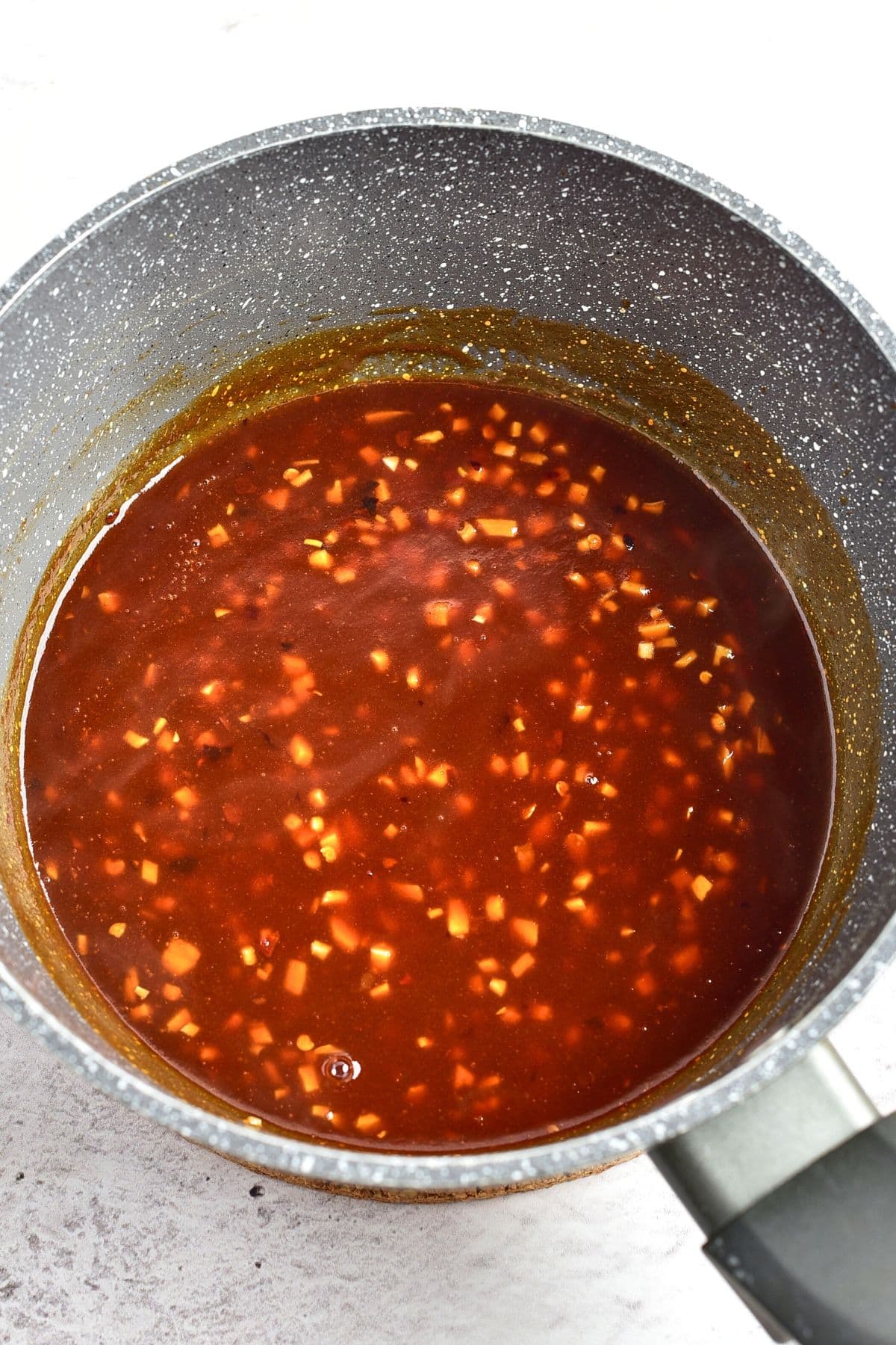 Preparing chili sauce in saucepan